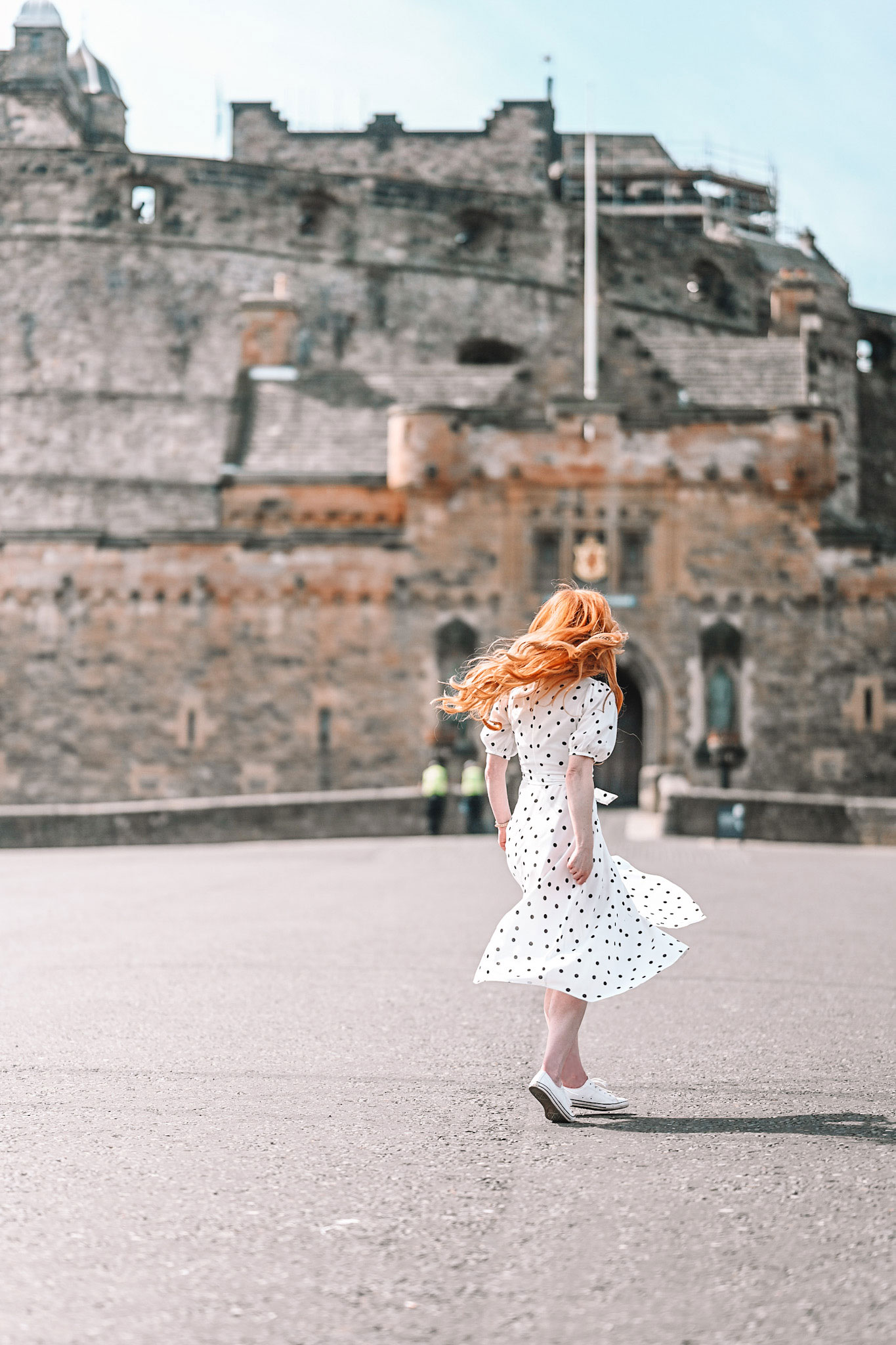 Amber spinning in a white dress on the Edinburgh Castle esplanade
