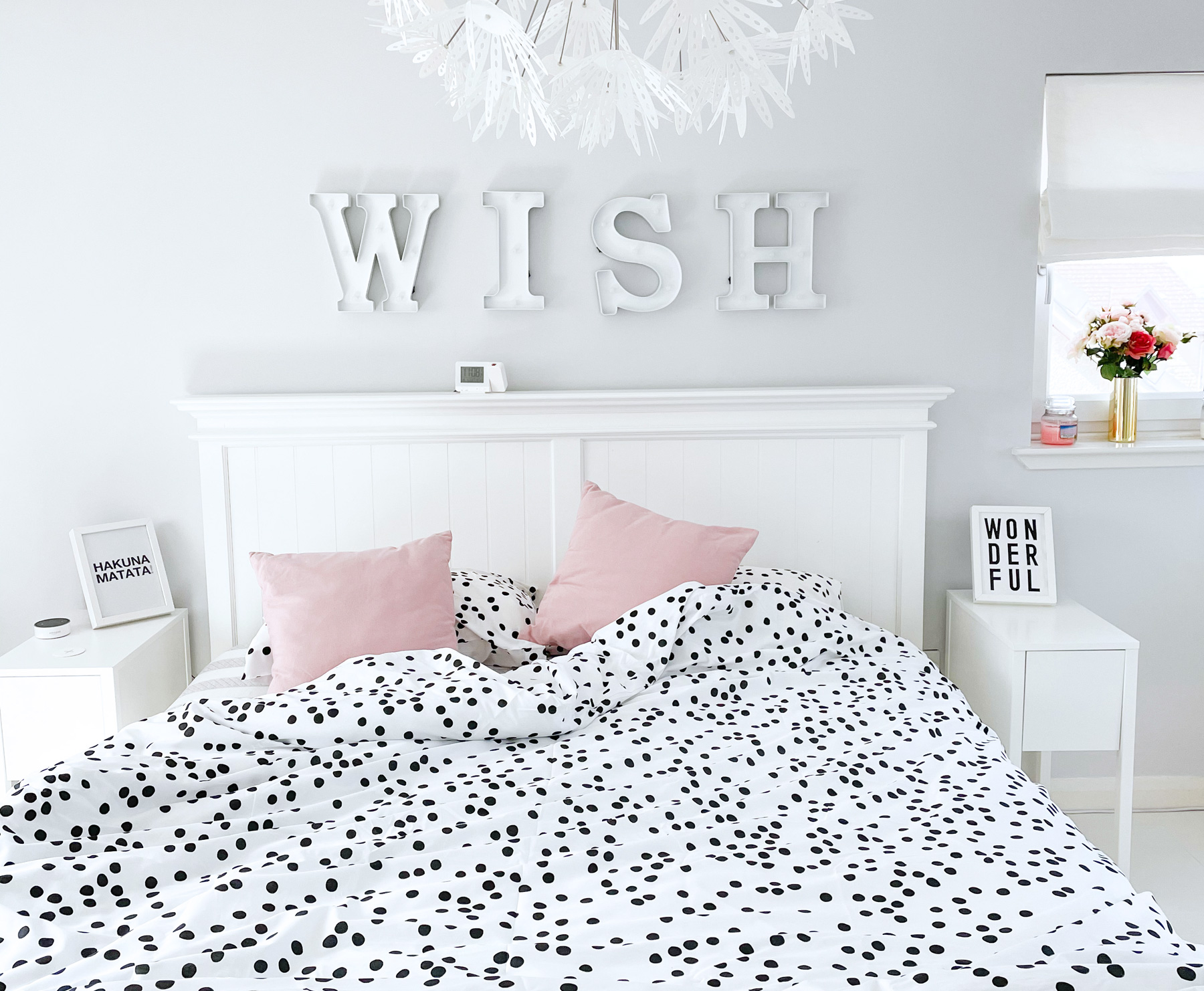 Superkingsize bed with white polka dot bedspread and pink cushions