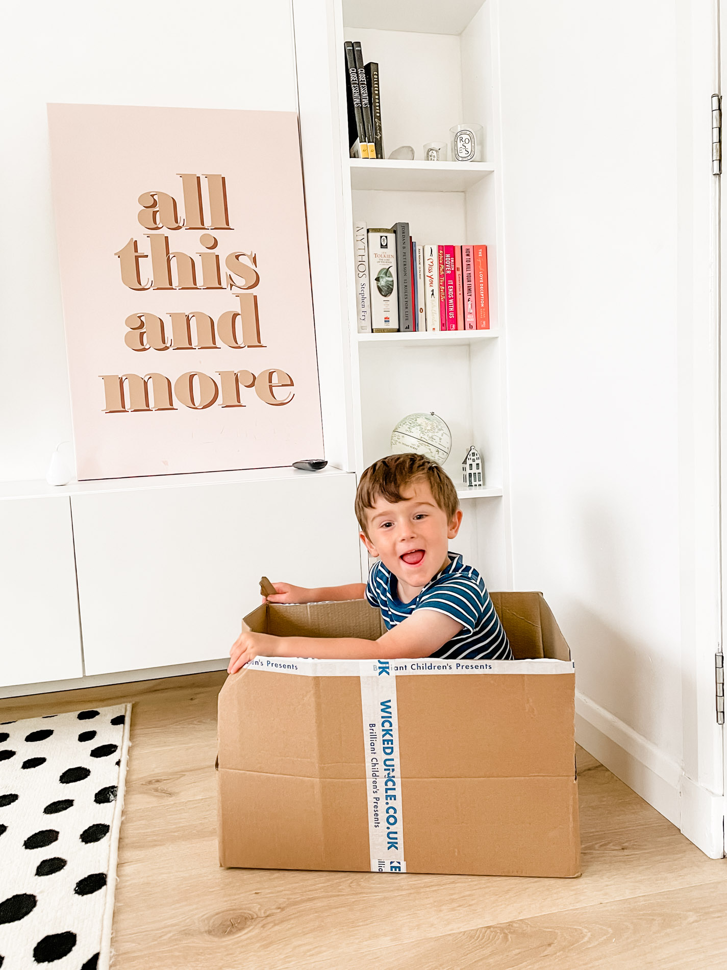 4-year-old playing in a cardboard box