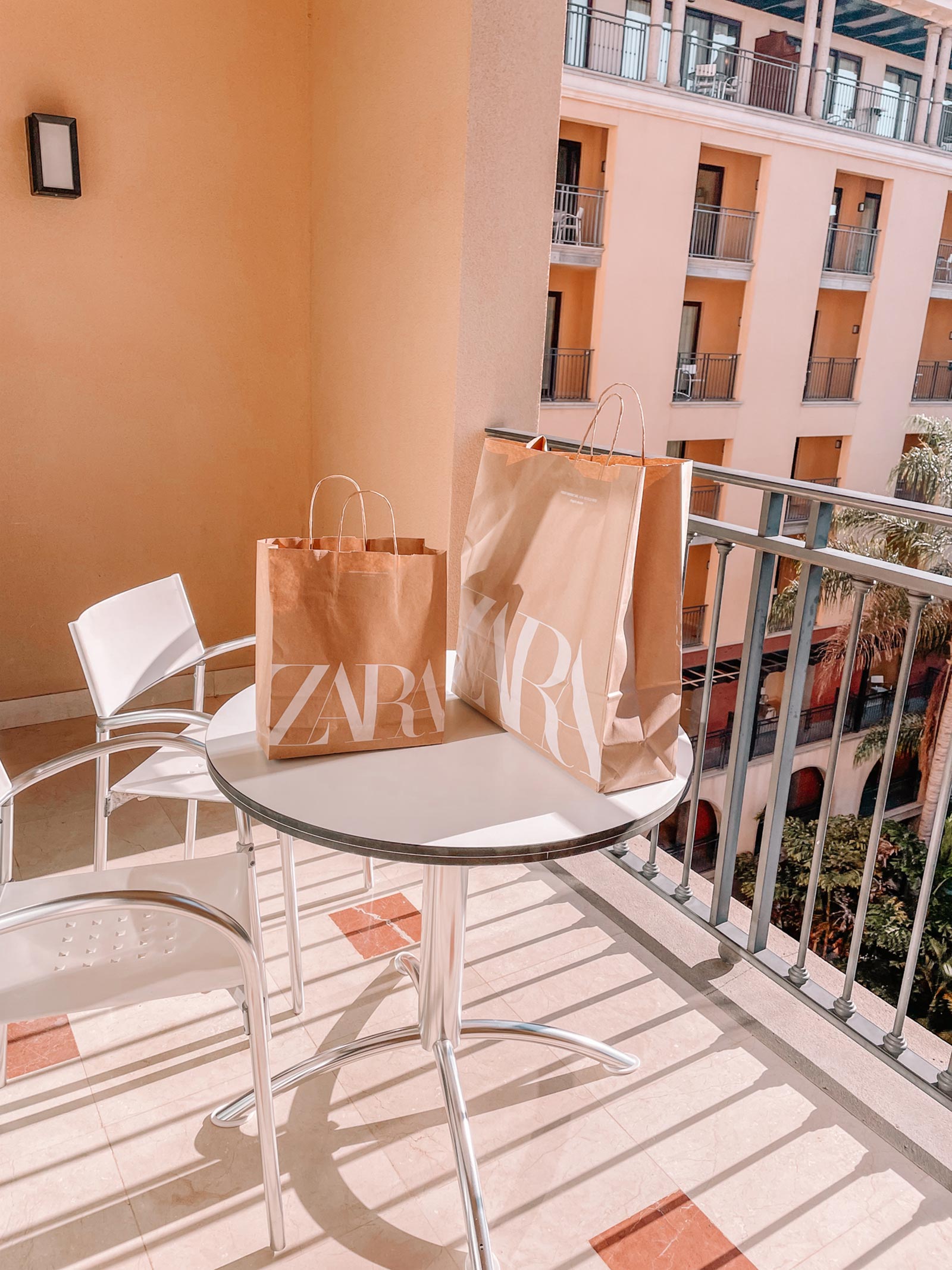 Zara shopping bags on a hotel balcony