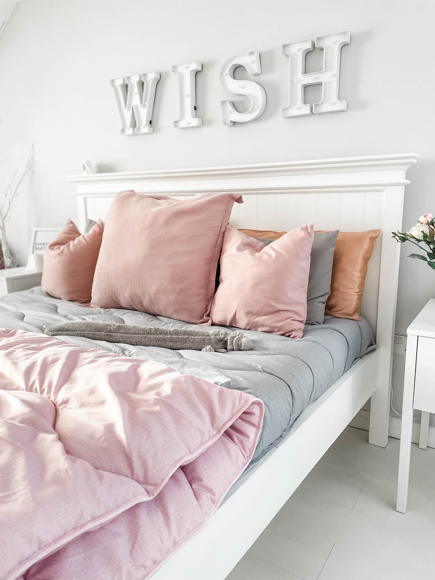 grey and pink coverless duvets on bed