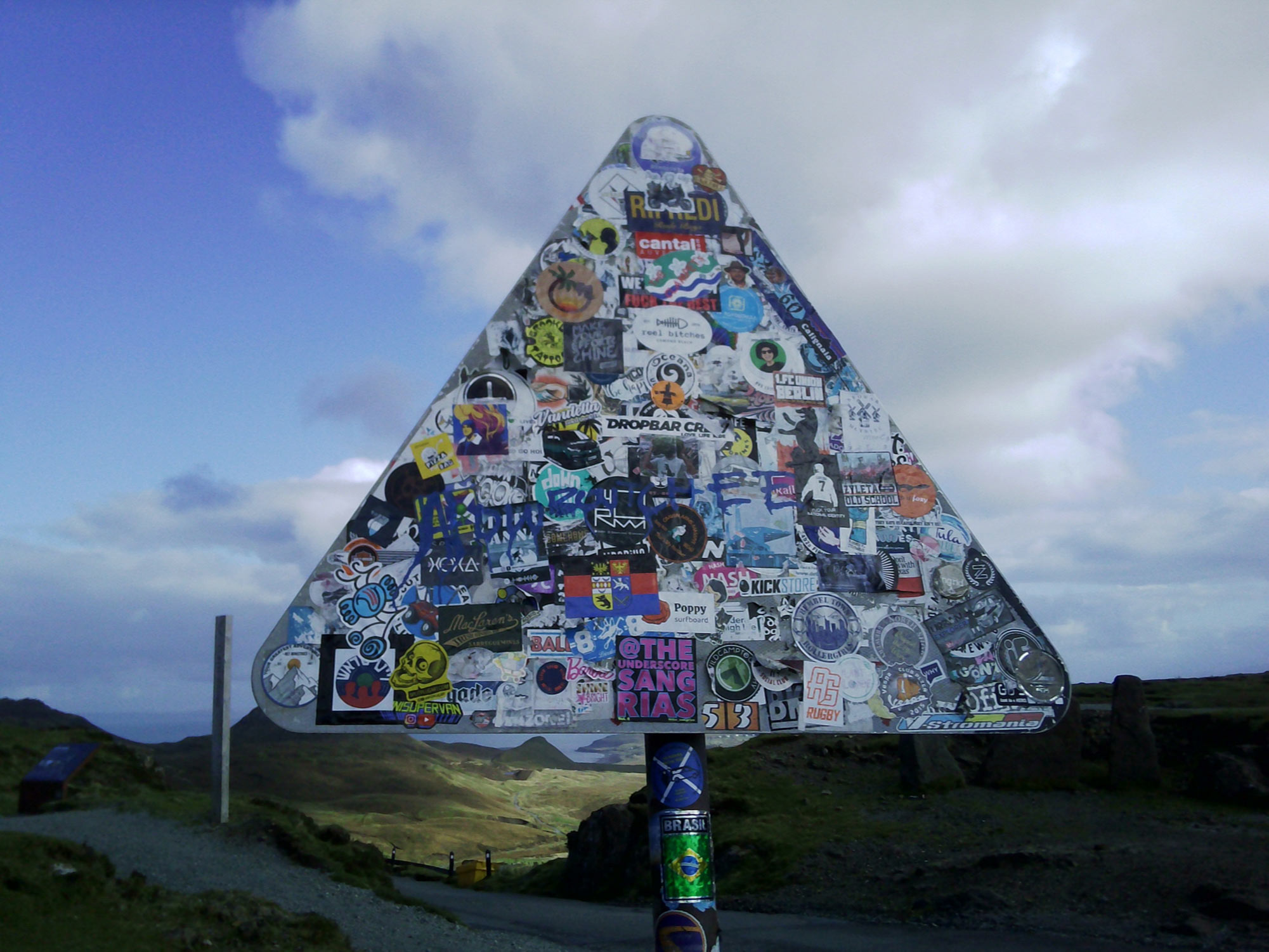 A road sign covered in stickers on the Isle of Skye