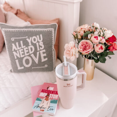 pink Stanley Quencher mug on bedside table